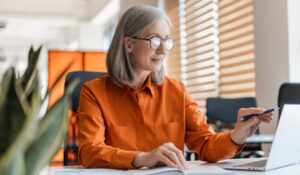 Aged worker at computer